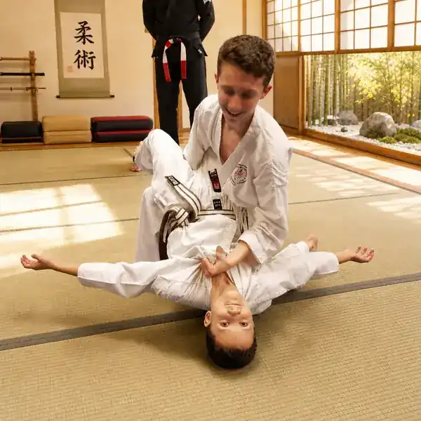 Children learning Ju-Jitsu ground control in class