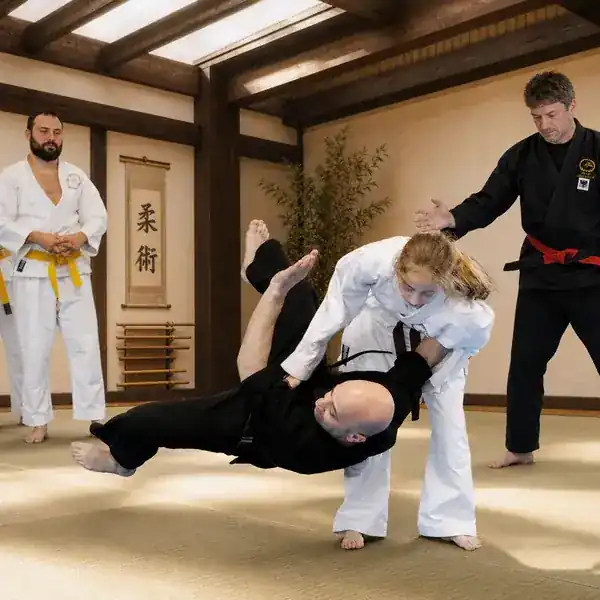 Women practising a controlled Ju-Jitsu throw
